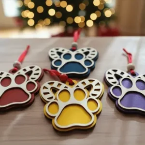 Wooden paw print Christmas ornament with festive details on white background