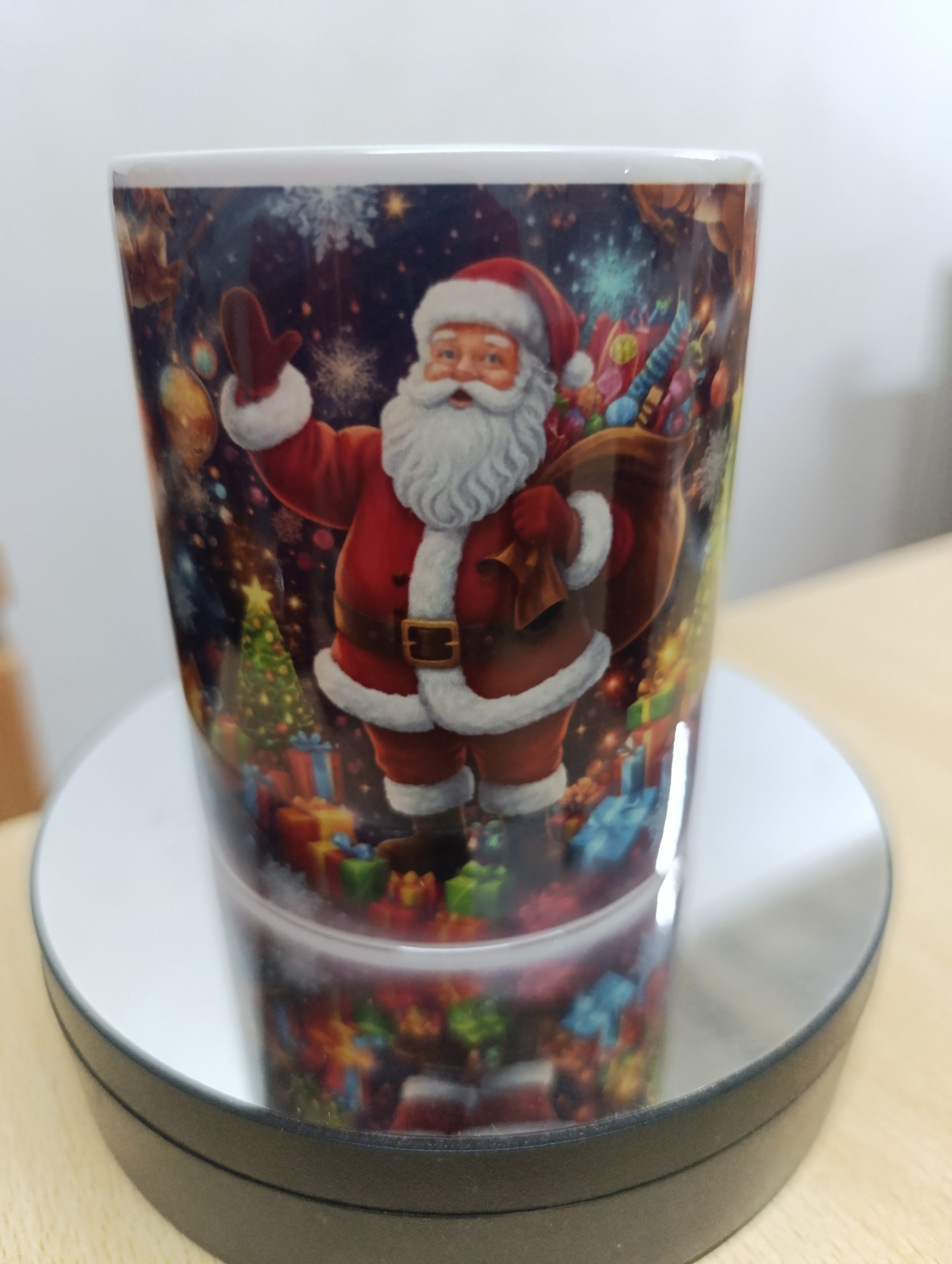 Ceramic mug with colorful Christmas scene featuring Santa and a decorated Christmas tree