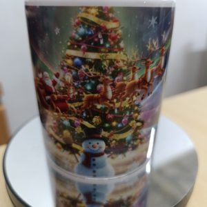 Ceramic mug with colorful Christmas scene featuring Santa, reindeer, snowman, and a decorated Christmas tree